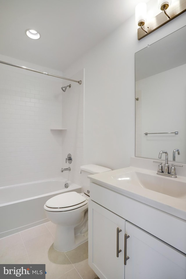 full bathroom featuring tiled shower / bath, vanity, tile patterned floors, and toilet