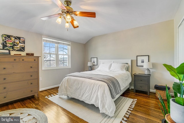 bedroom with lofted ceiling, dark hardwood / wood-style floors, and ceiling fan