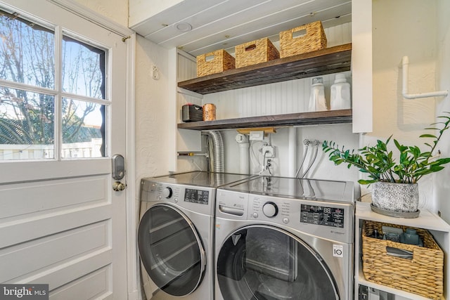 clothes washing area with independent washer and dryer