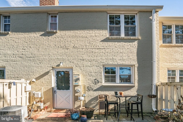 rear view of house featuring central AC and a patio