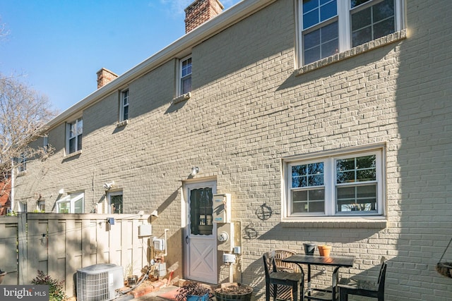 rear view of house featuring cooling unit