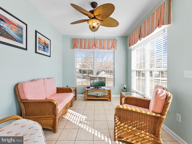 living area featuring ceiling fan and light tile patterned floors