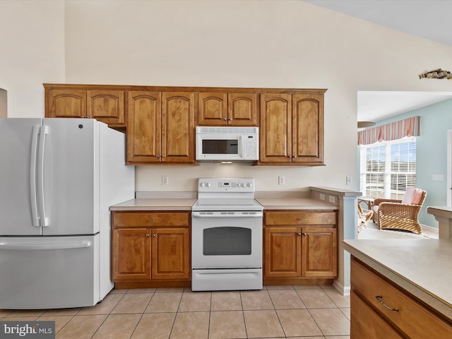 kitchen with light tile patterned floors and white appliances