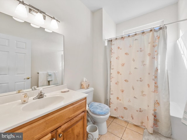 bathroom featuring vanity, tile patterned floors, and toilet