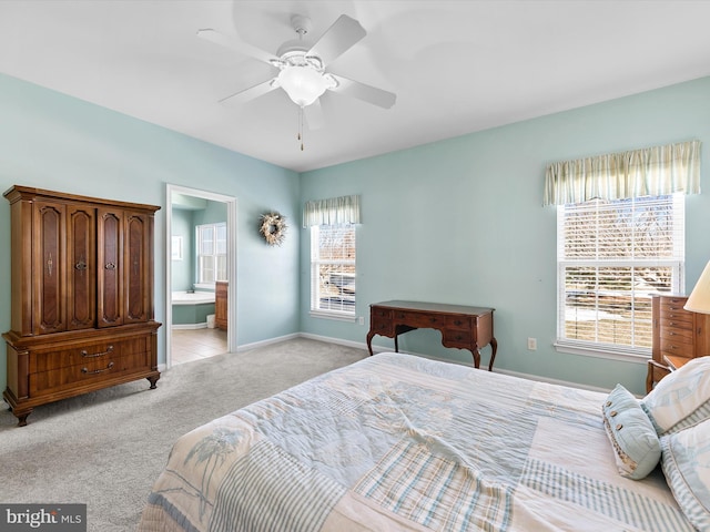 bedroom with ceiling fan, light carpet, and ensuite bath