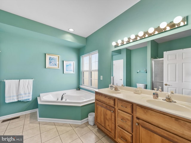 bathroom featuring independent shower and bath, vanity, and tile patterned floors