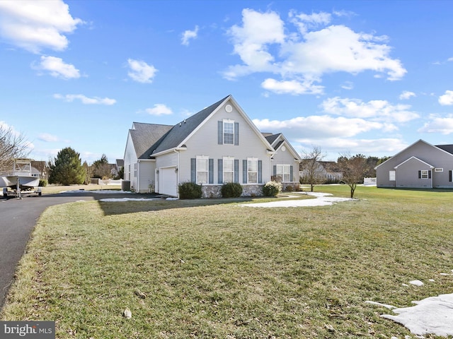 view of side of property featuring a yard and a garage