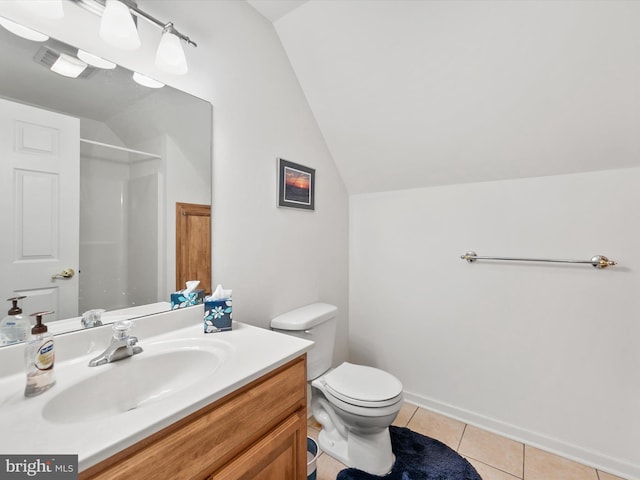 bathroom with tile patterned floors, lofted ceiling, toilet, and vanity