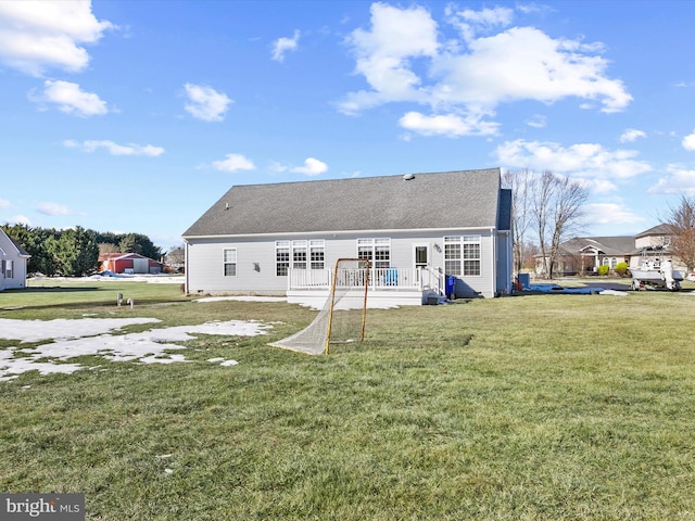 back of property featuring a yard