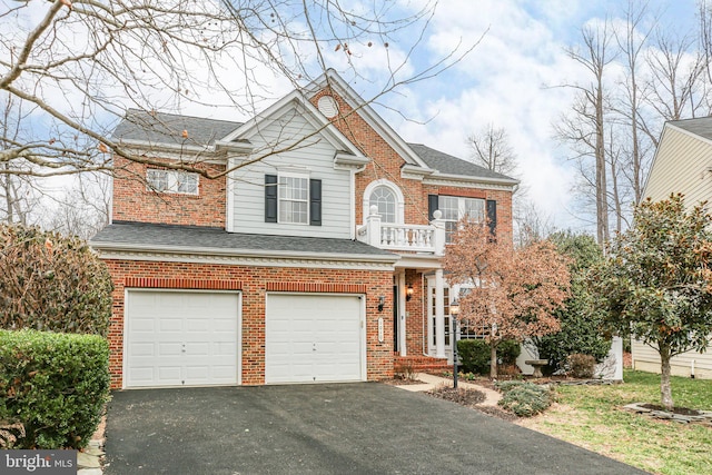 view of front facade with aphalt driveway, a balcony, an attached garage, and brick siding