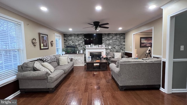 living room featuring ceiling fan, ornamental molding, and dark hardwood / wood-style floors