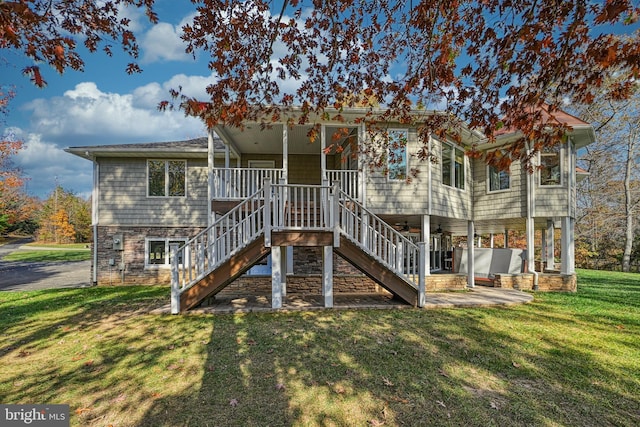 rear view of property featuring a yard and a patio area