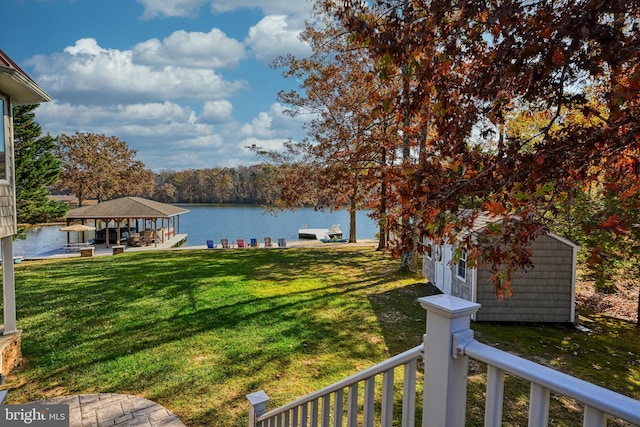 view of yard featuring a water view, a gazebo, and a boat dock