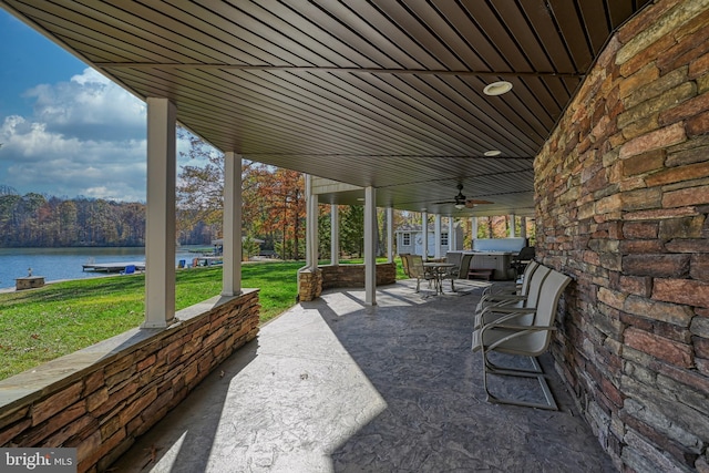 view of patio featuring a water view and ceiling fan