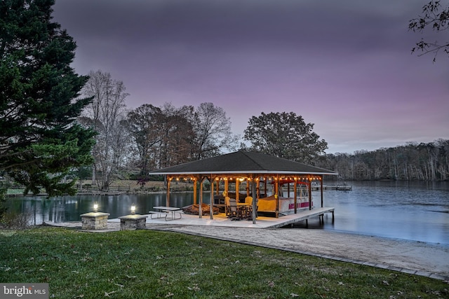 dock area with a water view and a yard