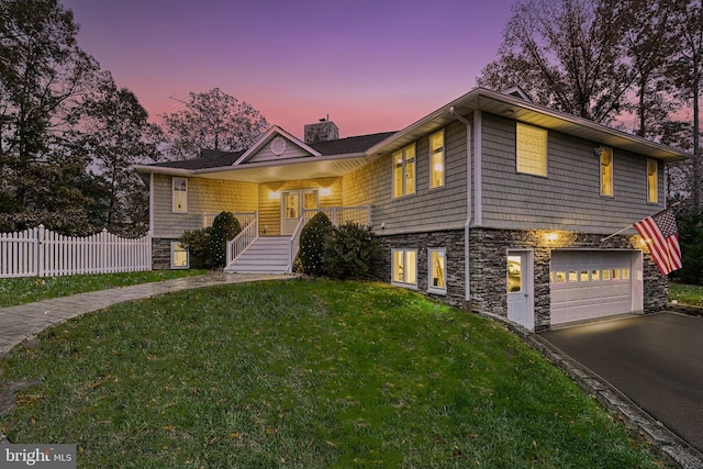 view of front of house with a yard and a garage