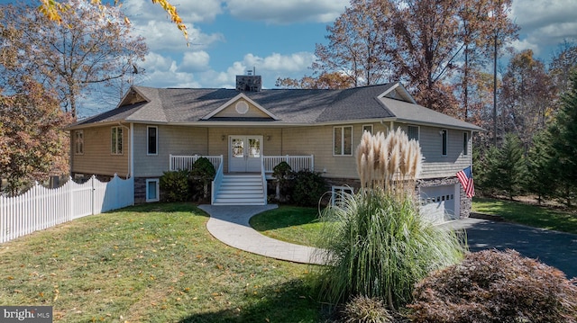 view of front facade with covered porch, a garage, central AC, a front yard, and french doors