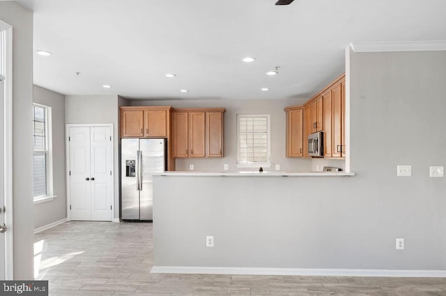 kitchen featuring stainless steel appliances, recessed lighting, light countertops, light wood-style floors, and baseboards