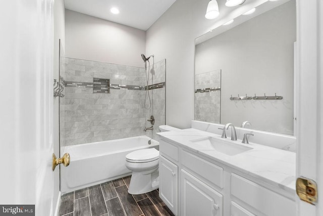 full bath featuring shower / washtub combination, wood finish floors, vanity, and toilet