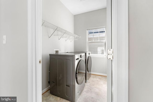 laundry area featuring laundry area, independent washer and dryer, and baseboards