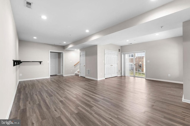 interior space with stairway, visible vents, dark wood-type flooring, and recessed lighting