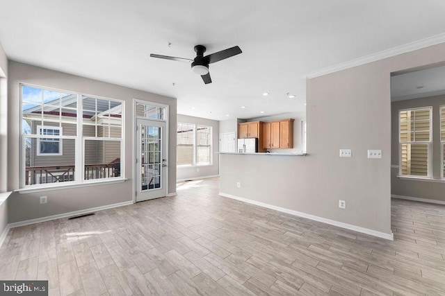 unfurnished living room with recessed lighting, a ceiling fan, baseboards, ornamental molding, and light wood finished floors