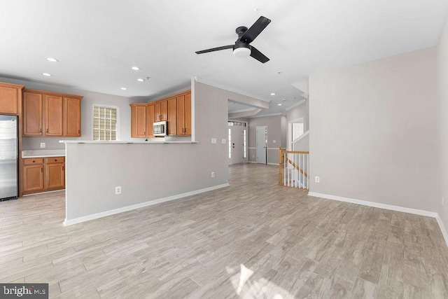 unfurnished living room with light wood-style floors, recessed lighting, and baseboards