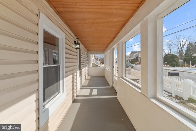 unfurnished sunroom with wooden ceiling