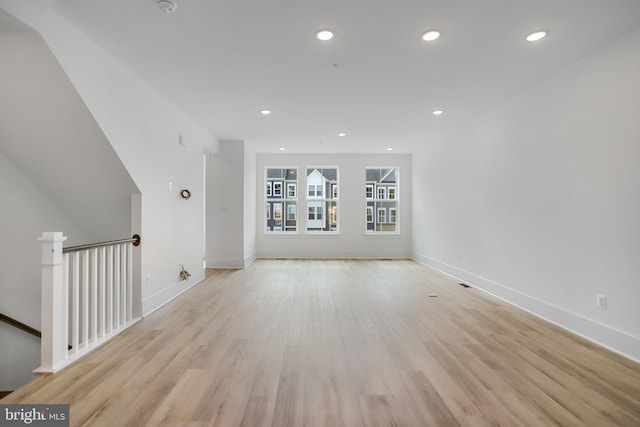 additional living space with light hardwood / wood-style flooring