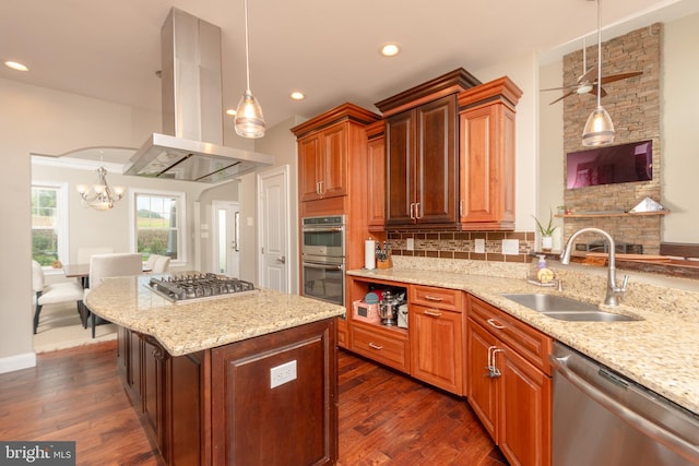 kitchen featuring sink, hanging light fixtures, dark hardwood / wood-style floors, stainless steel appliances, and light stone countertops