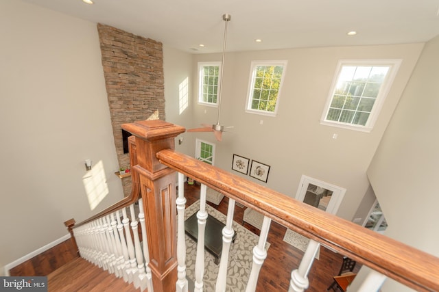 staircase with hardwood / wood-style floors and a healthy amount of sunlight