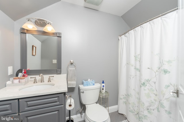 bathroom featuring lofted ceiling, toilet, a shower with shower curtain, and vanity