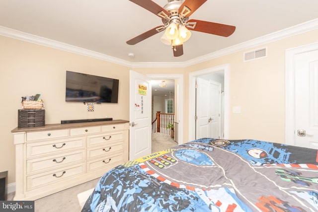 carpeted bedroom featuring crown molding and ceiling fan