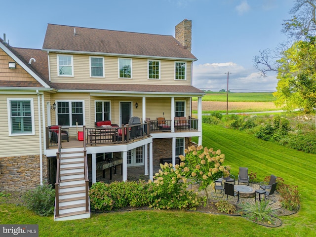 back of property featuring a yard, a patio area, a balcony, and a deck