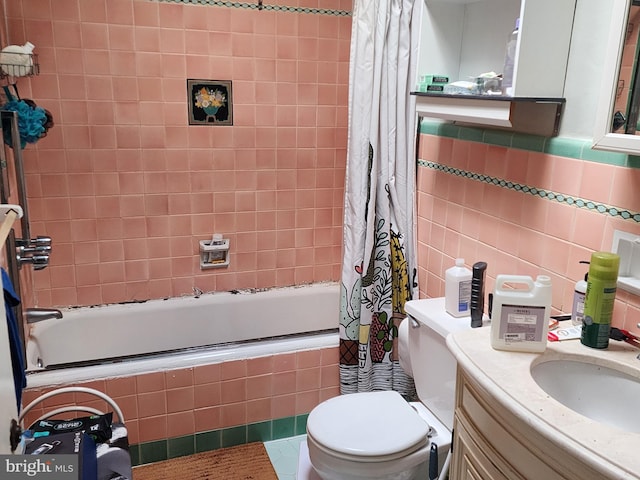 full bathroom featuring tile patterned floors, toilet, tile walls, vanity, and shower / bathtub combination with curtain