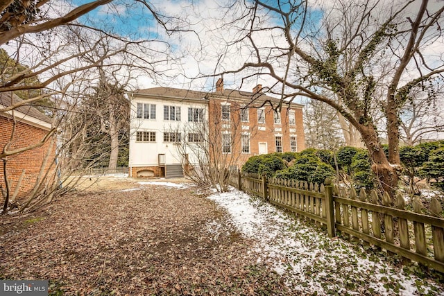 view of snow covered rear of property