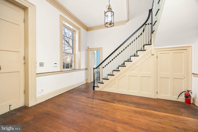 entryway featuring dark hardwood / wood-style flooring and ornamental molding