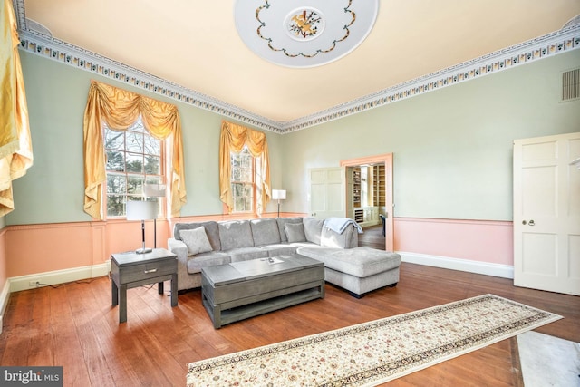 living room featuring crown molding and wood-type flooring