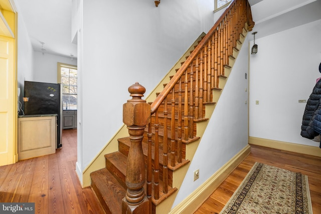 staircase with wood-type flooring