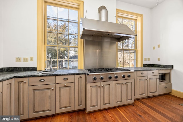 kitchen featuring sink, stainless steel gas cooktop, exhaust hood, and dark hardwood / wood-style flooring