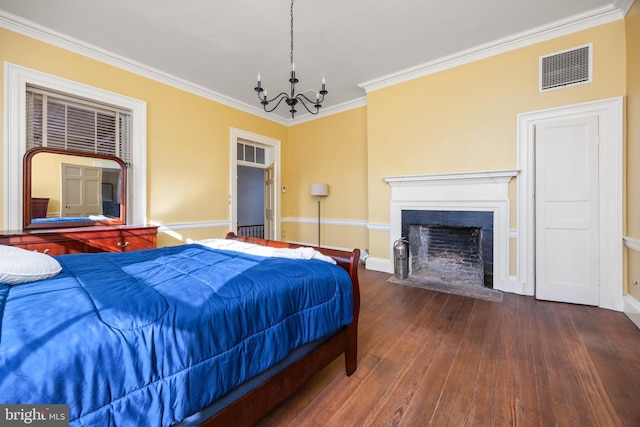 bedroom featuring dark wood-type flooring, crown molding, and a notable chandelier