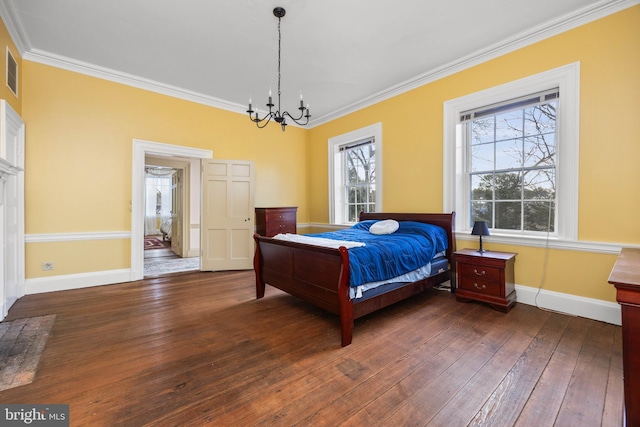 bedroom with crown molding, dark hardwood / wood-style flooring, and an inviting chandelier