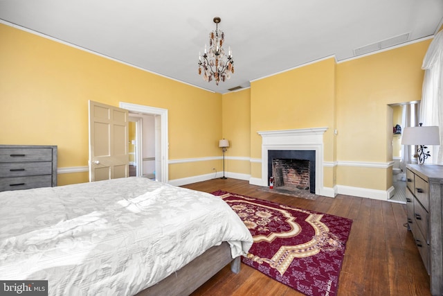 bedroom featuring dark hardwood / wood-style floors and a notable chandelier