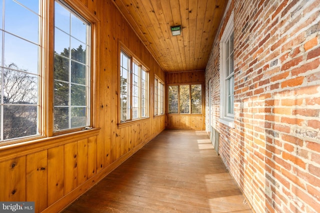 unfurnished sunroom featuring wood ceiling