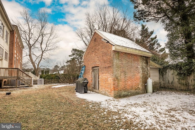 view of snow covered exterior featuring a yard