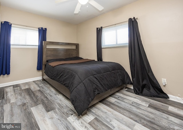 bedroom with hardwood / wood-style floors and ceiling fan