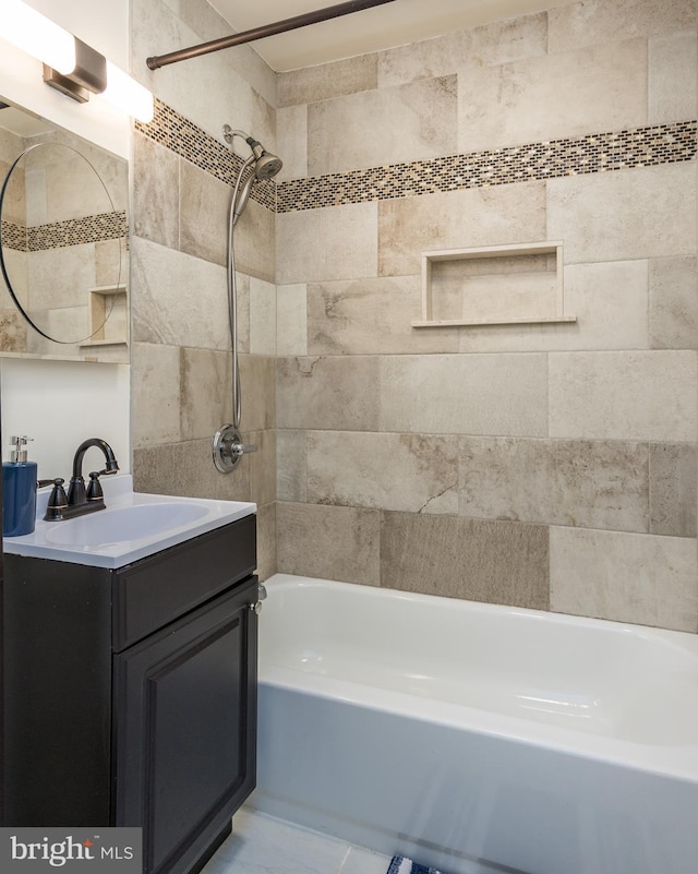 bathroom with vanity and tiled shower / bath combo