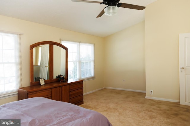 carpeted bedroom featuring ceiling fan and vaulted ceiling