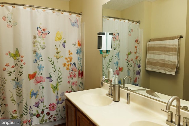 bathroom featuring vanity and a shower with curtain