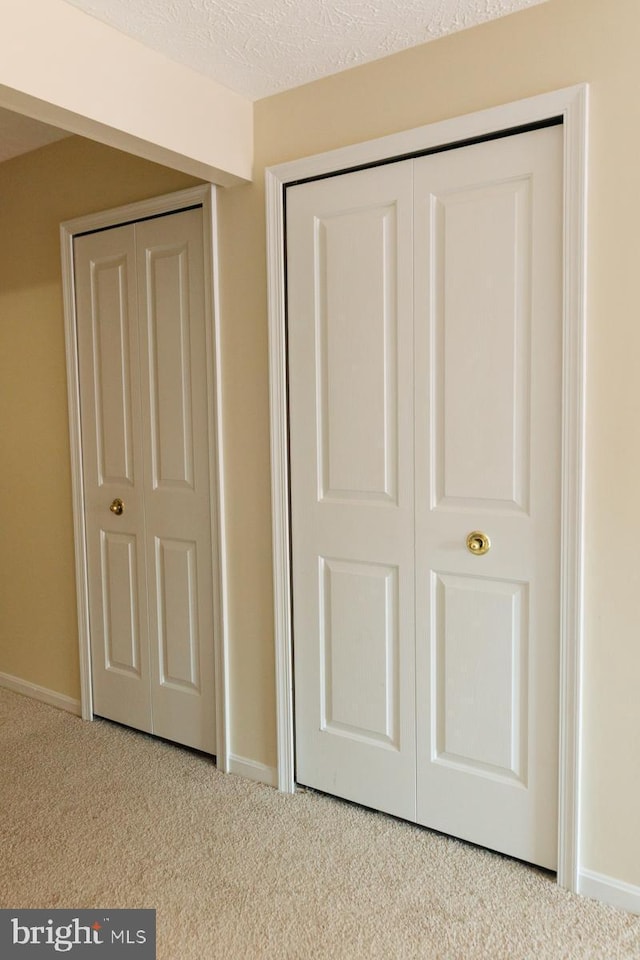 unfurnished bedroom featuring carpet and a textured ceiling